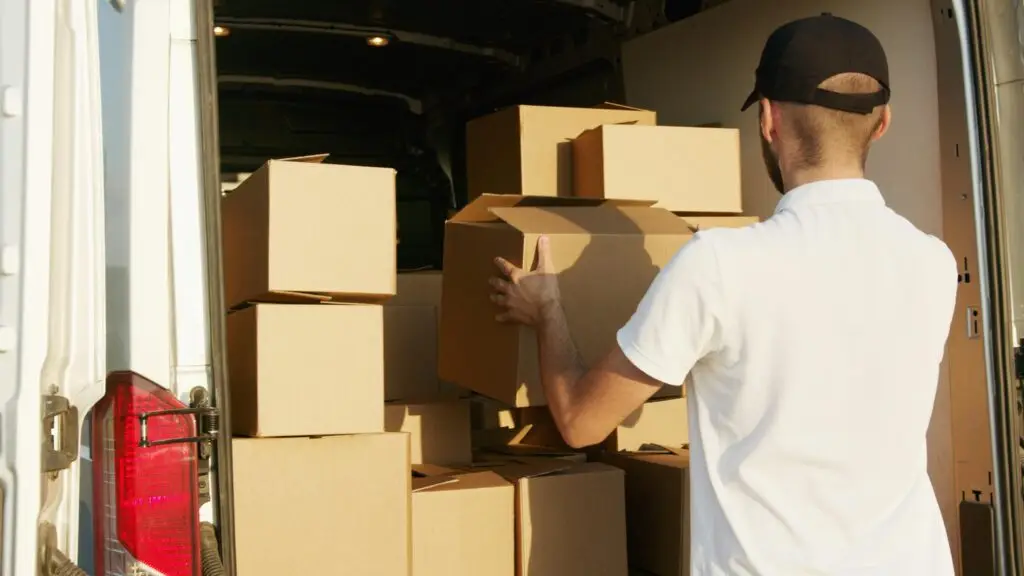 moving, tips, yucatan, Courier arranging cardboard boxes in a delivery van during daytime.